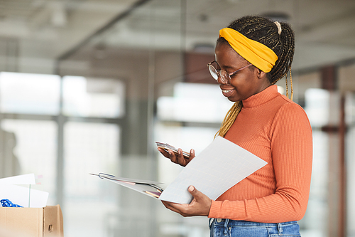 African female designer opening the folder she working at office