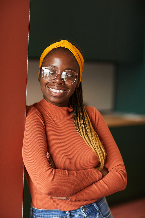 African young happy woman in casual clothing and with stylish hairstyle smiling at camera