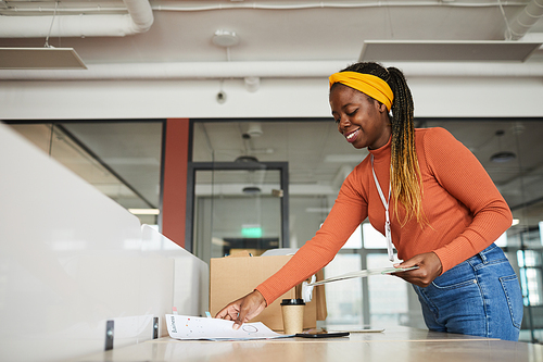 African female designer working at her workplace at office