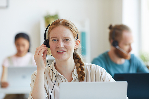 Telemarketing headset woman from call center woman in headphones speaking with client during her work at office