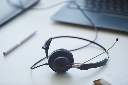 Close-up of headphones lying on the table of customer service operator at office