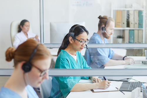 Medical team using headsets while working at their workplace in medical call center