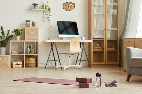 Image of living room with modern furniture and sports equipment prepared for sport