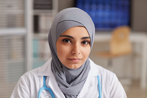 Close-up of muslim woman looking at camera while working at hospital