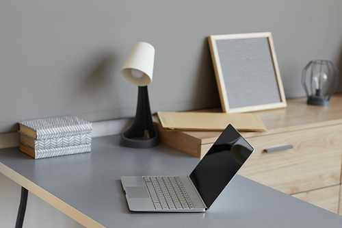 Image of empty modern workplace with laptop on it at office