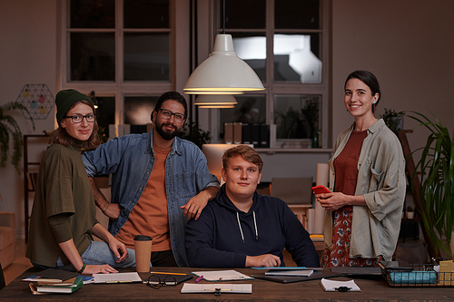 Portrait of group of business people looking at camera while working in team