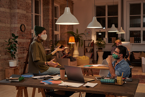 Group of business people in protective masks planning work together at office