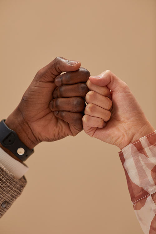 Close-up of two friends greeting each other isolated on beige background