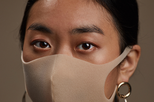 Close-up of Asian woman in protective mask during pandemic