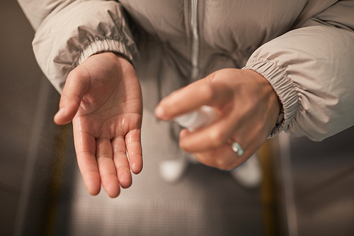 Close-up of woman applying antiseptic on her hands