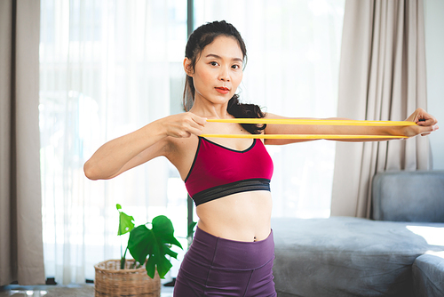 young woman doing exercise at home, fitness sport for body building and training, health active happy girl lifestyle