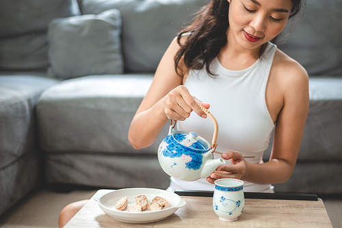Asian woman person relaxing with hot tea to drink at home, tea cup for happy lifestyle in morning