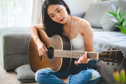 woman person playing acoustic guitar music instrument at home, young Asian musician girl lifestyle