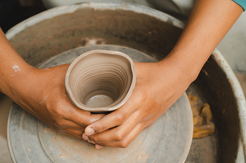 happy smiling girl having fun to learning and work with craft art of clay hand-made workshop in ceramic studio, little ceramist enjoy in creative handcraft hobby with pottery artisan school class