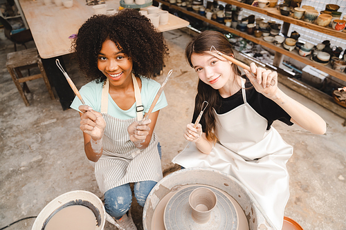 happy smiling girl having fun to learning and work with craft art of clay hand-made workshop in ceramic studio, little ceramist enjoy in creative handcraft hobby with pottery artisan school class