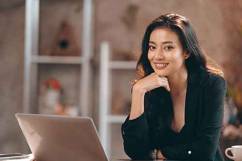 Portrait of young confident smiling Asian business woman leader, successful entrepreneur, elegant professional company executive ceo manager, working in co-working space business office