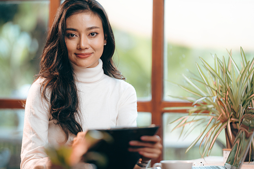 Portrait of young confident smiling Asian business woman leader, successful entrepreneur, elegant professional company executive ceo manager, working in co-working space business office