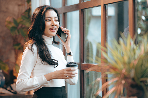 Portrait of young confident smiling Asian business woman leader, successful entrepreneur, elegant professional company executive ceo manager, working in co-working space business office