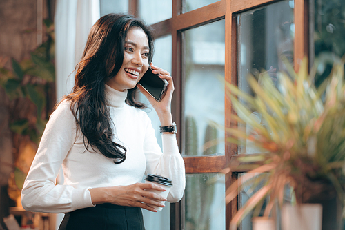 Portrait of young confident smiling Asian business woman leader, successful entrepreneur, elegant professional company executive ceo manager, working in co-working space business office