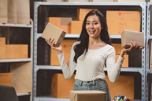 Young woman working at home for packeting parcel box to shipping delivery service to customer, online business marketing concept