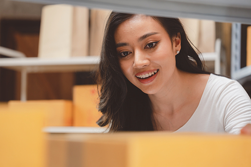 woman entrepreneur's hand holding package of parcel box, Preparing pack delivery packet product for selling online of home shipping service, Startup with small business marketing concept