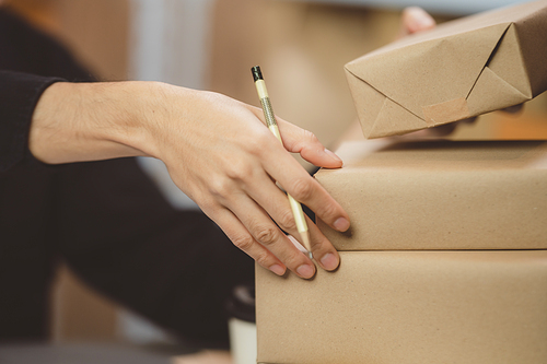 Young woman working at home for packeting parcel box to shipping delivery service to customer, online business marketing concept