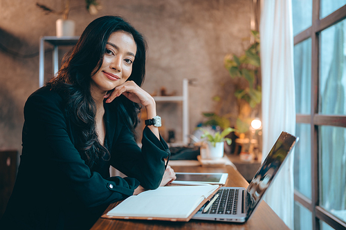 Portrait of young confident smiling Asian business woman leader, successful entrepreneur, elegant professional company executive ceo manager, working in co-working space business office