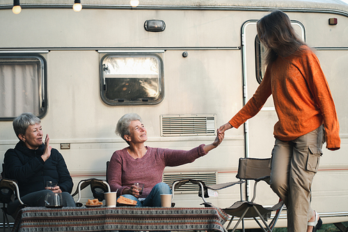 woman family having fun with food of picnic camp in the nature morning, summer travel vacation lifestyle of mother and girl at adventure forest park landscape in holiday, outdoors activity breakfast