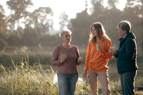 female family in holiday with hot drink of coffee or tea, young woman person in vacation tent camping lifestyle with nature to adventure mountain hiking travel, happy together with morning drink