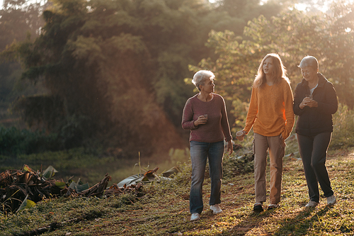 family of senior woman and teenager talking about activity recreation and picnic while coffee breakfast together in morning weekend, camping travel vacations trip in holiday, outdoor leisure party