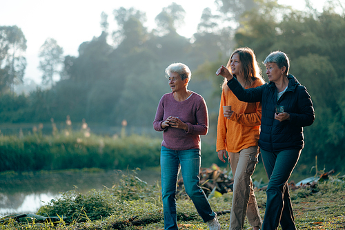 family of senior woman and teenager talking about activity recreation and picnic while coffee breakfast together in morning weekend, camping travel vacations trip in holiday, outdoor leisure party