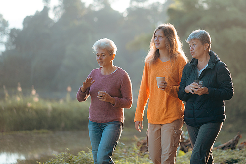 family of senior woman and teenager talking about activity recreation and picnic while coffee breakfast together in morning weekend, camping travel vacations trip in holiday, outdoor leisure party