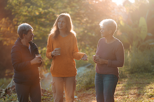 family of senior woman and teenager talking about activity recreation and picnic while coffee breakfast together in morning weekend, camping travel vacations trip in holiday, outdoor leisure party