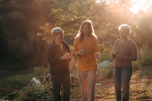 family of senior woman and teenager talking about activity recreation and picnic while coffee breakfast together in morning weekend, camping travel vacations trip in holiday, outdoor leisure party