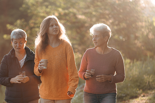 family of senior woman and teenager talking about activity recreation and picnic while coffee breakfast together in morning weekend, camping travel vacations trip in holiday, outdoor leisure party