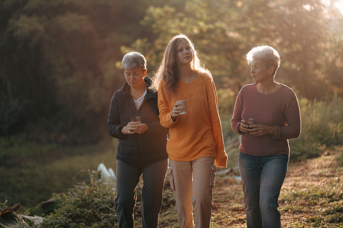 female family in holiday with hot drink of coffee or tea, young woman person in vacation tent camping lifestyle with nature to adventure mountain hiking travel, happy together with morning drink