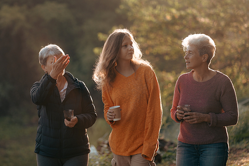 family of senior woman and teenager talking about activity recreation and picnic while coffee breakfast together in morning weekend, camping travel vacations trip in holiday, outdoor leisure party