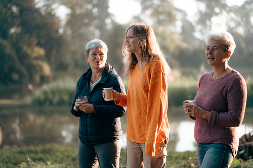 family of senior woman and teenager talking about activity recreation and picnic while coffee breakfast together in morning weekend, camping travel vacations trip in holiday, outdoor leisure party