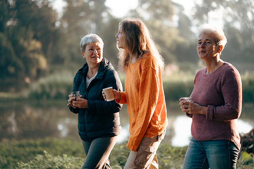 family of senior woman and teenager talking about activity recreation and picnic while coffee breakfast together in morning weekend, camping travel vacations trip in holiday, outdoor leisure party