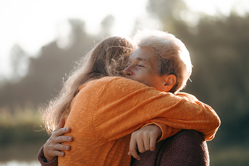 happiness female childhood family bonding mother lifestyle at nature outdoors, children daughter girl having affectionate embracing love with eltern woman, cheerful hug and smiling togetherness