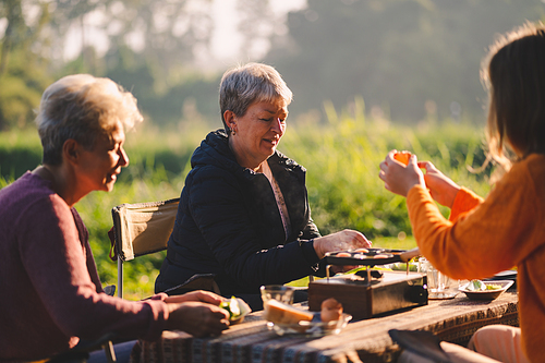 mother and children lifestyle in vacation camping concept, nature, woman person family are happy fun to eating picnic breakfast food at outdoors summer travel, girl with adventure trip holiday leisure