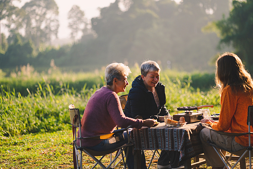 female family in holiday with hot drink of coffee or tea, young woman person in vacation tent camping lifestyle with nature to adventure mountain hiking travel, happy together with morning drink