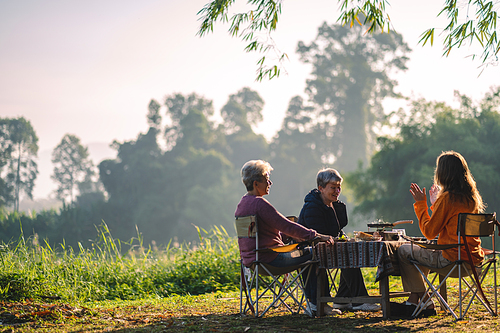 mother and children lifestyle in vacation camping concept, nature, woman person family are happy fun to eating picnic breakfast food at outdoors summer travel, girl with adventure trip holiday leisure