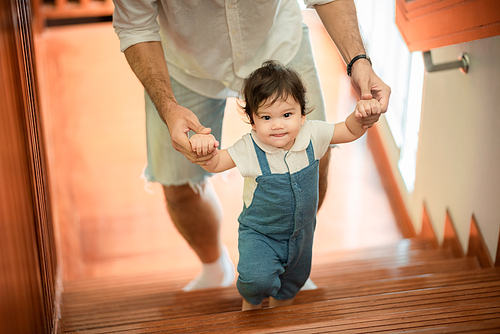 father help children baby to walk, childhood family people with little cute toddler child son, happy learning in first step with support together from father at home