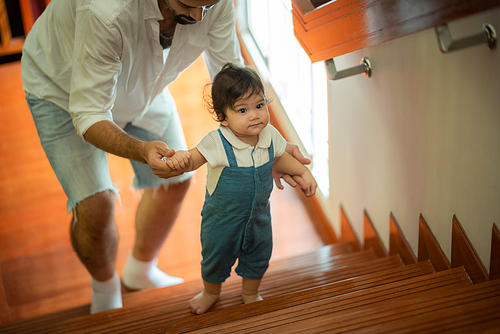 cute toddler little child family concept, baby learning to walk with father and mother to help care and holding hand, first step with childhood parent support, small love portrait little boy at home