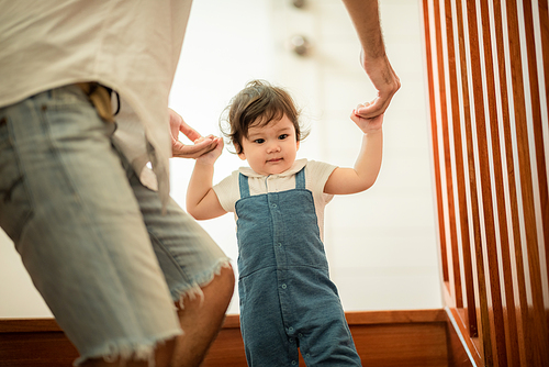 father help children baby to walk, childhood family people with little cute toddler child son, happy learning in first step with support together from father at home