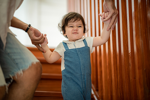 father help children baby to walk, childhood family people with little cute toddler child son, happy learning in first step with support together from father at home