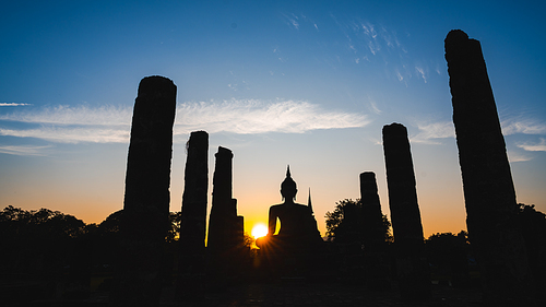 Historic Town of Sukhothai temple park, Ancient Buddha Statue at sunset Sukhothai historical park, Mahathat Temple