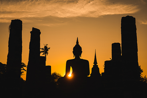 Historic Town of Sukhothai temple park, Ancient Buddha Statue at sunset Sukhothai historical park, Mahathat Temple