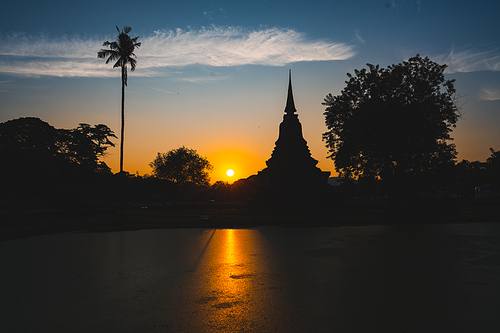 Historic Town of Sukhothai temple park, Ancient Buddha Statue at sunset Sukhothai historical park, Mahathat Temple